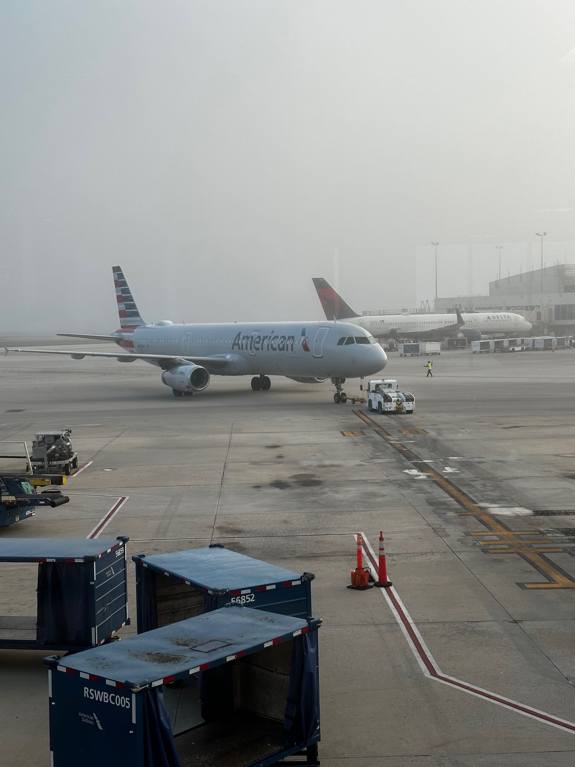 Foggy morning at Logan with A319 pushing back from the gate