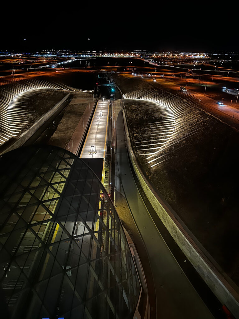 Airport Hotels: Worth the Premium? view from Westin Denver onto the train from the airport to the city at night