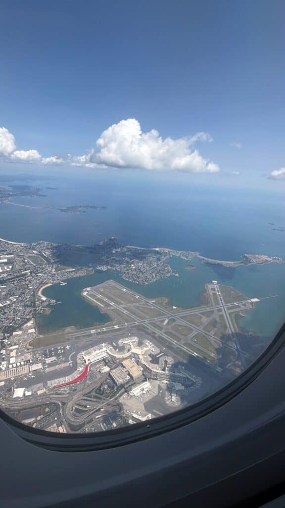 Aerial view of Boston Logan International Airport (BOS) and Boston Harbor from an airplane window. - Available as a print