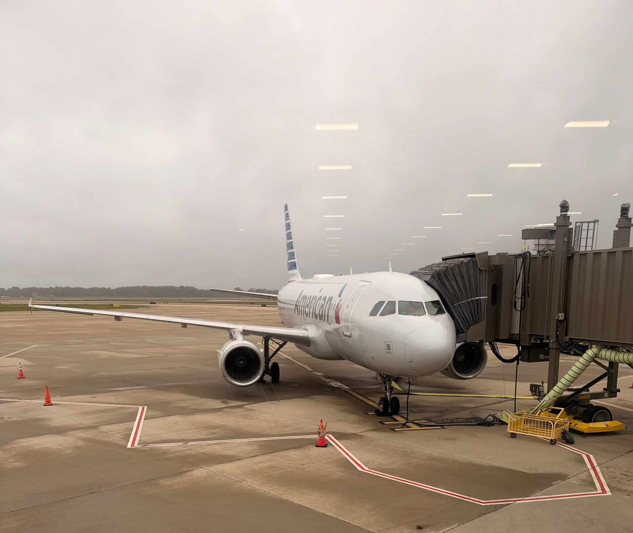 American Airlines Airbus jet parked at a jet bridge on a gray, overcast day at Richmond International Airport