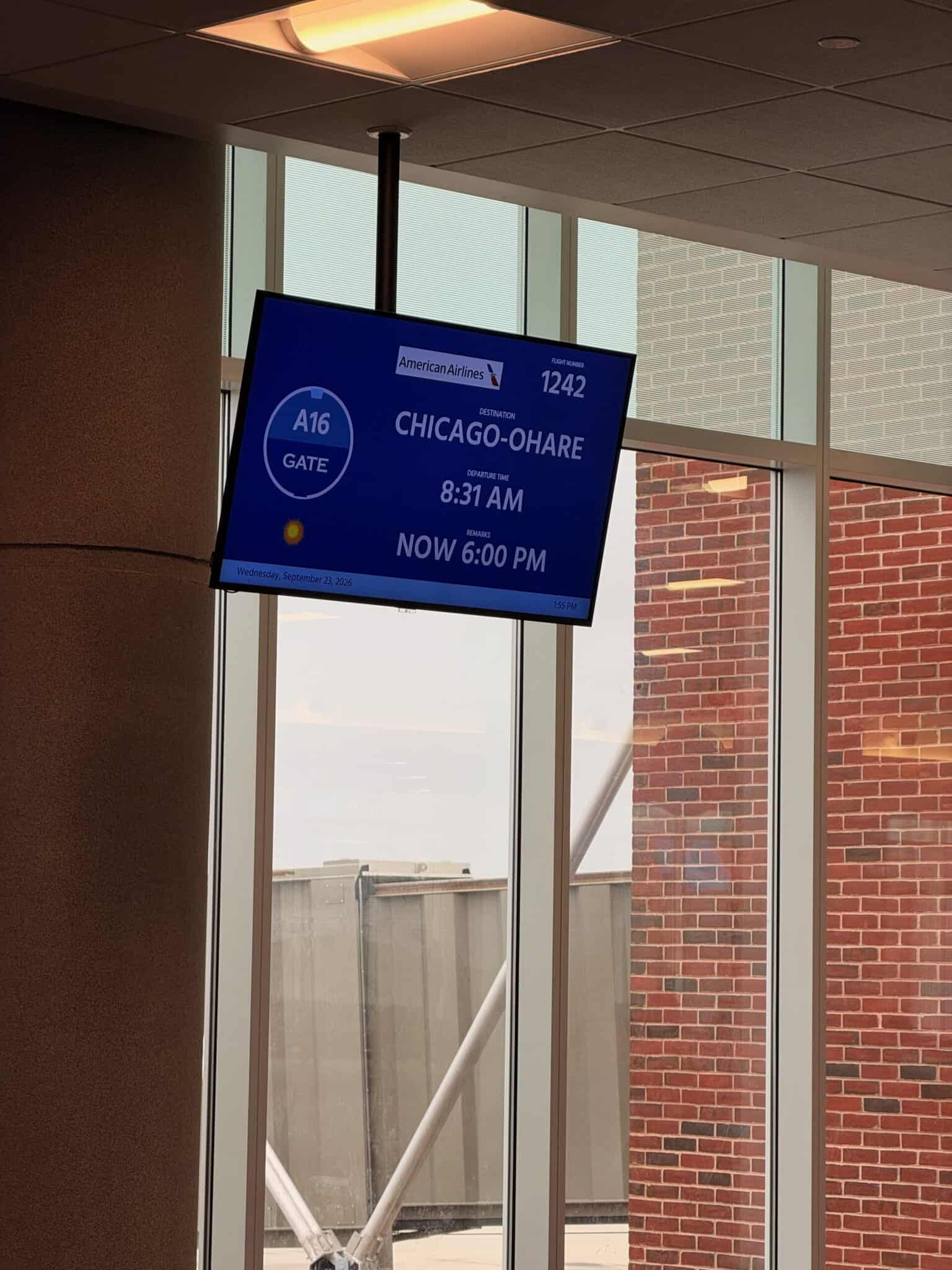 Gate A16 departure board at RIC showing American Airlines flight 1242 to Chicago O'Hare, scheduled 8:31 AM, now 6:00 PM