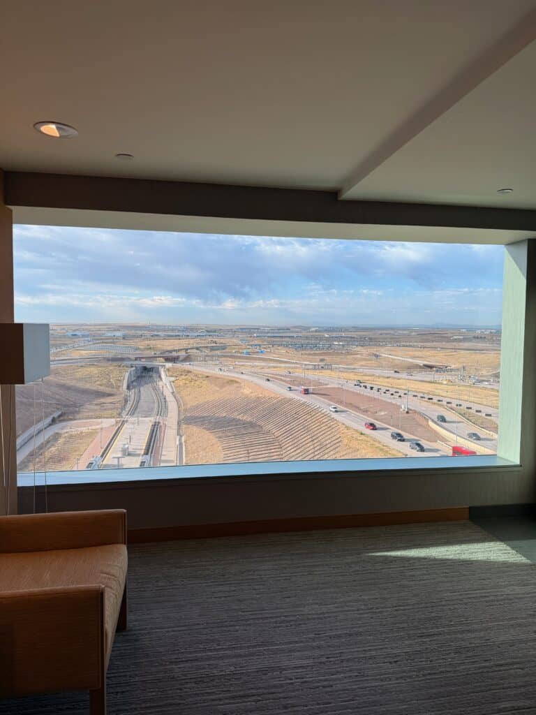 Daytime view from a Westin Denver International hotel room overlooking the airport rail platform and access roads - aviation photography by Anthony Yandow