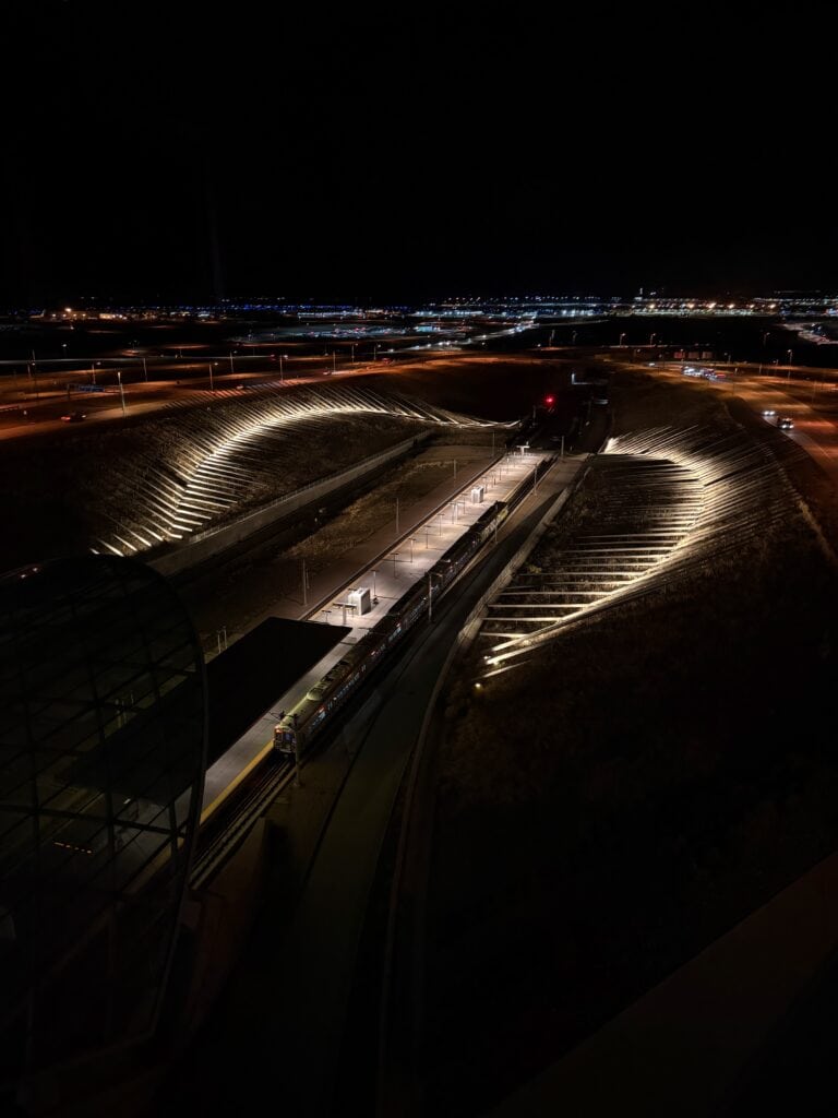 Night view from a Westin Denver International hotel room overlooking the airport rail platform - aviation photography by Anthony Yandow