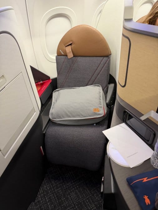 Is Extra Legroom Worth It? A Traveler's Honest Review Business class window seat with lie-flat legroom on a long-haul flight